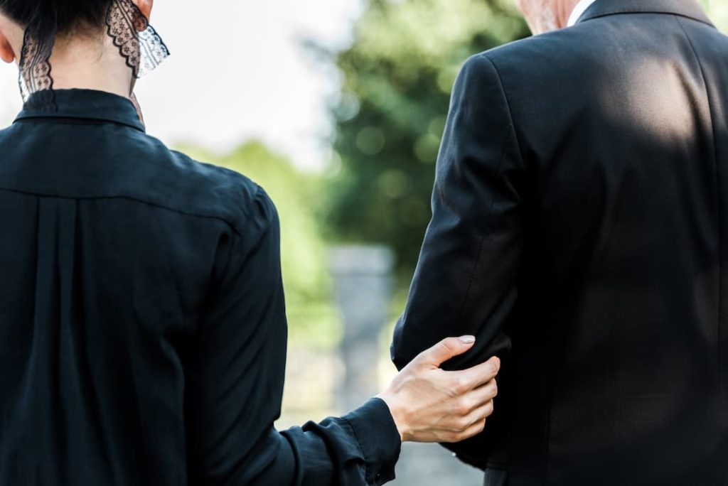 woman and man comforting each other after a death