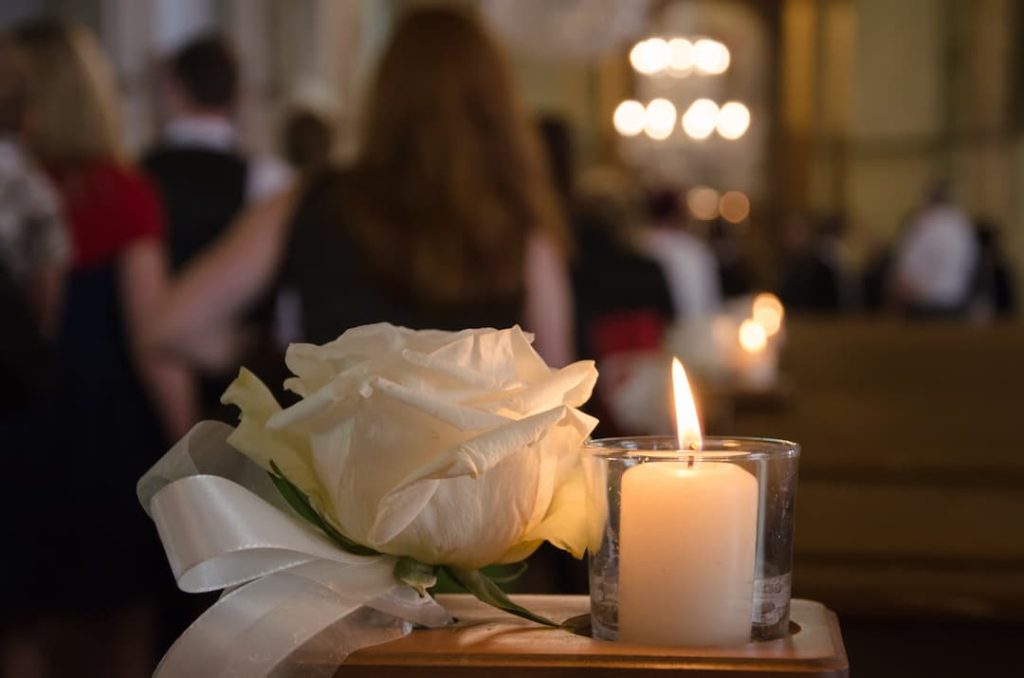 Rose and candle lighted in funeral home